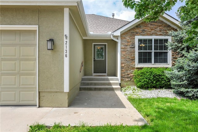 2136 Alder St, Leavenworth, KS 66048 - entrance to property with stucco siding, stone siding, and a garage