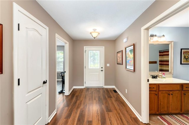 2136 Alder St, Leavenworth, KS 66048 - foyer featuring baseboards and dark wood finished floors