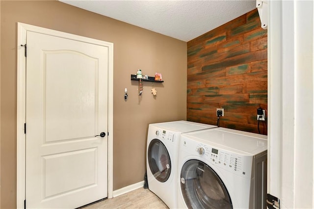 2136 Alder St, Leavenworth, KS 66048 - washroom with laundry area, washing machine and dryer, baseboards, wooden walls, and a textured ceiling