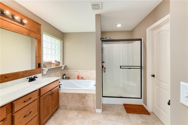 2136 Alder St, Leavenworth, KS 66048 - bathroom featuring a bath, visible vents, tile patterned flooring, a shower stall, and vanity