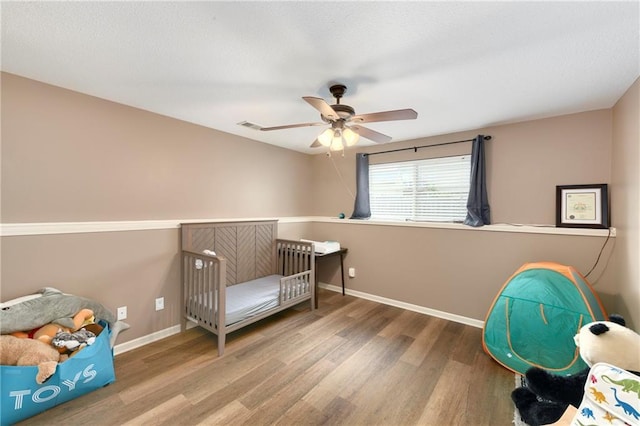 2136 Alder St, Leavenworth, KS 66048 - bedroom featuring baseboards, a ceiling fan, wood finished floors, and visible vents