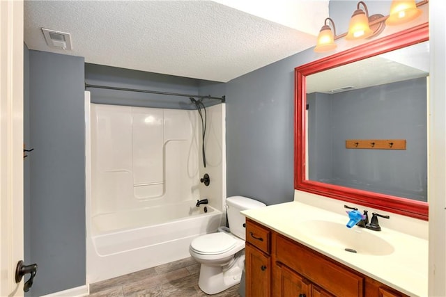 2136 Alder St, Leavenworth, KS 66048 - bathroom featuring visible vents, vanity, wood finished floors, toilet, and a textured ceiling