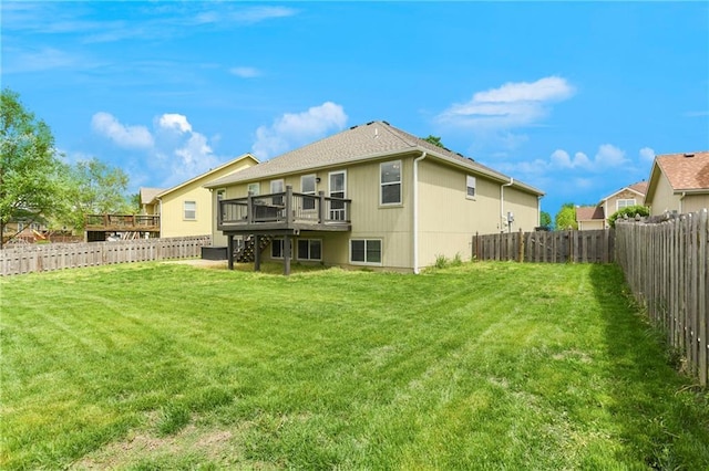2136 Alder St, Leavenworth, KS 66048 - back of property featuring a lawn, a deck, and a fenced backyard