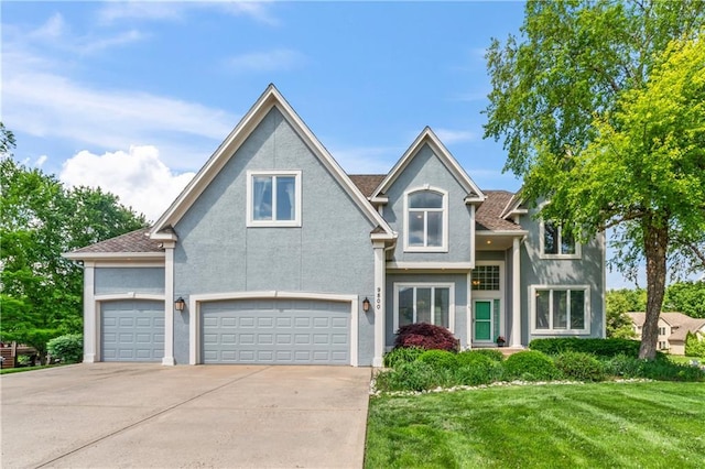 9800 W 147th St, Overland Park, KS 66221 - view of front facade featuring stucco siding, a front yard, concrete driveway, and a garage