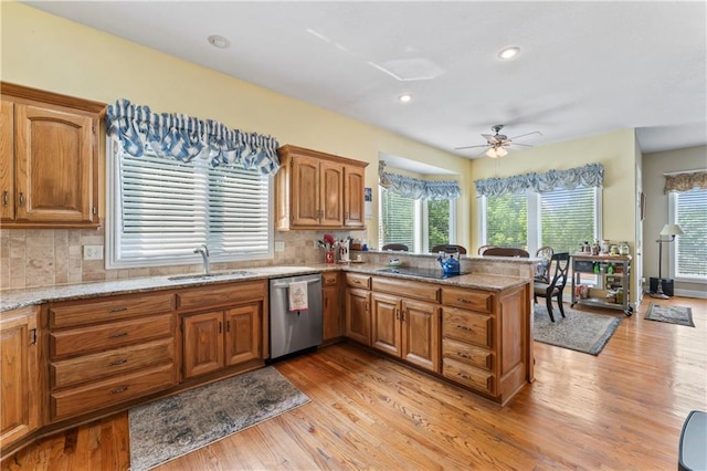 9800 W 147th St, Overland Park, KS 66221 - kitchen with stainless steel dishwasher, a peninsula, light wood-type flooring, backsplash, and recessed lighting