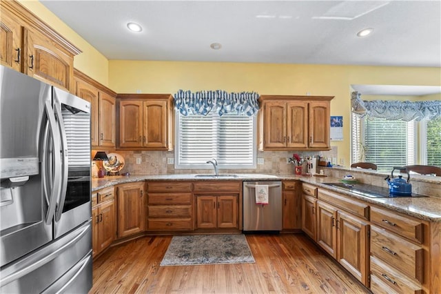 9800 W 147th St, Overland Park, KS 66221 - kitchen with appliances with stainless steel finishes, light wood finished floors, tasteful backsplash, brown cabinets, and recessed lighting