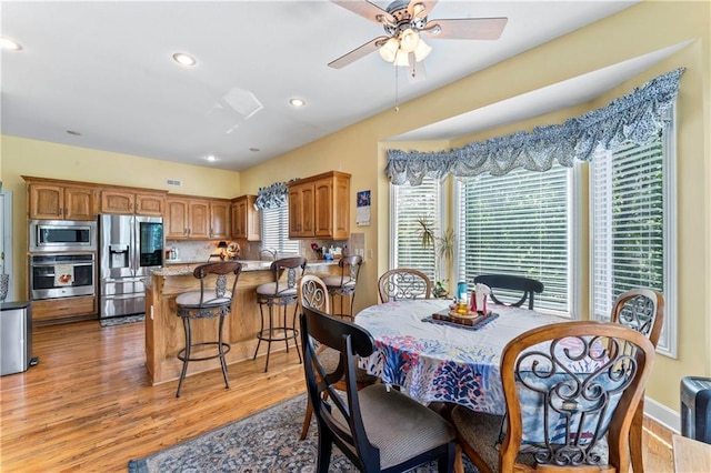 9800 W 147th St, Overland Park, KS 66221 - dining room with light wood finished floors, a ceiling fan, and recessed lighting