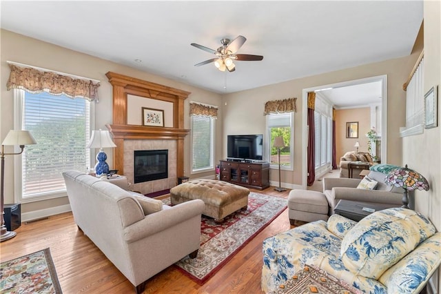 9800 W 147th St, Overland Park, KS 66221 - living room with a ceiling fan, healthy amount of natural light, light wood finished floors, and a tiled fireplace