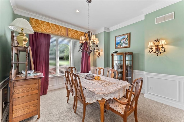 9800 W 147th St, Overland Park, KS 66221 - dining room featuring a chandelier, light colored carpet, crown molding, a wainscoted wall, and a decorative wall