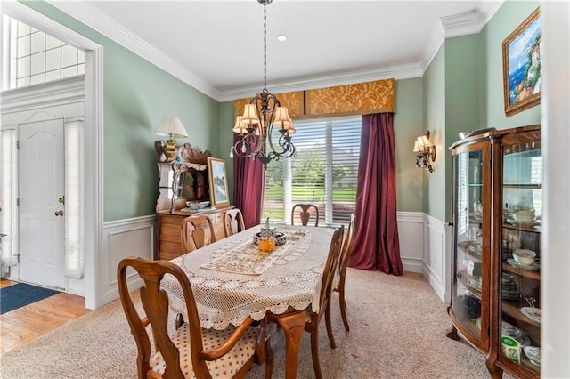 9800 W 147th St, Overland Park, KS 66221 - dining room with a chandelier, a wainscoted wall, carpet floors, crown molding, and a decorative wall