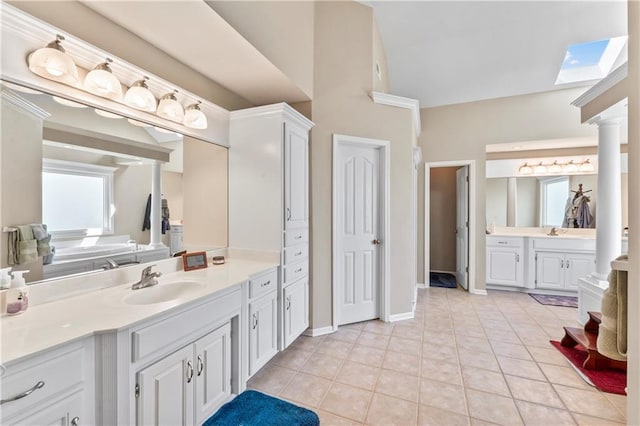 9800 W 147th St, Overland Park, KS 66221 - bathroom with two vanities, tile patterned flooring, ornate columns, and high vaulted ceiling