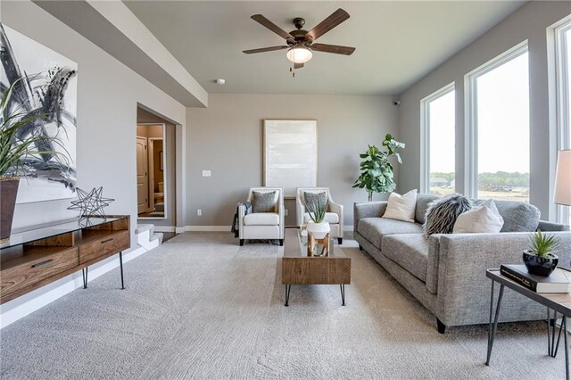 9634 N Colrain Ave, Kansas City, MO 64154 - living area featuring light colored carpet, ceiling fan, and baseboards