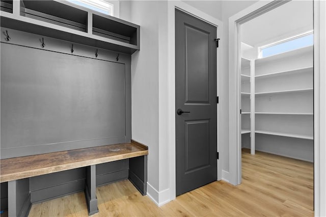mudroom with light wood-style flooring and baseboards