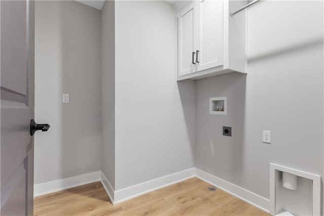 clothes washing area with hookup for an electric dryer, light wood-style floors, baseboards, hookup for a washing machine, and cabinet space