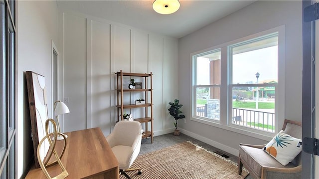 office space with baseboards, visible vents, and light colored carpet