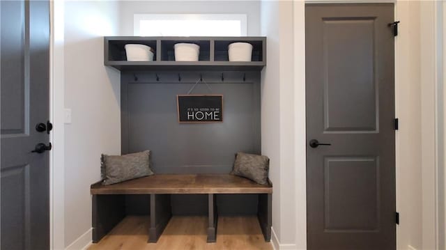 mudroom with wood finished floors and baseboards