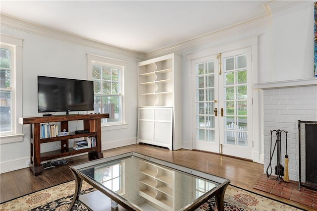 living area featuring crown molding, french doors, wood finished floors, and baseboards