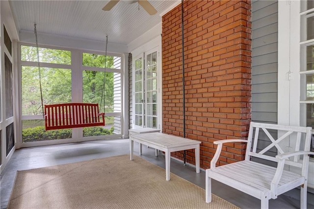 sunroom featuring ceiling fan