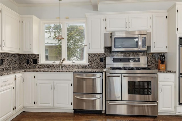 kitchen with dark stone counters, white cabinetry, and stainless steel appliances