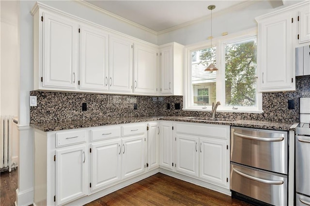 kitchen with dark stone counters, dishwasher, white cabinetry, and a sink