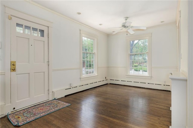 foyer entrance featuring wood finished floors, a ceiling fan, and crown molding