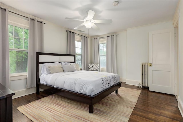 bedroom featuring baseboards, radiator heating unit, a ceiling fan, and dark wood-style flooring