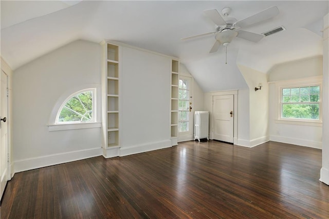 bonus room with radiator, visible vents, vaulted ceiling, and hardwood / wood-style flooring