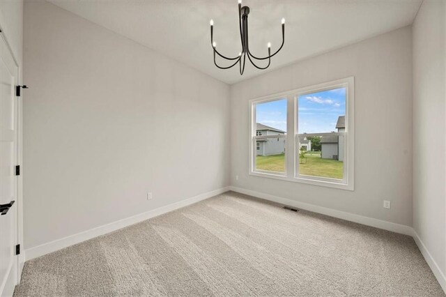 interior space featuring carpet flooring, baseboards, a notable chandelier, and visible vents