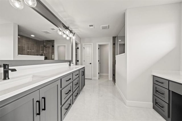 bathroom with double vanity, visible vents, a shower stall, and a sink