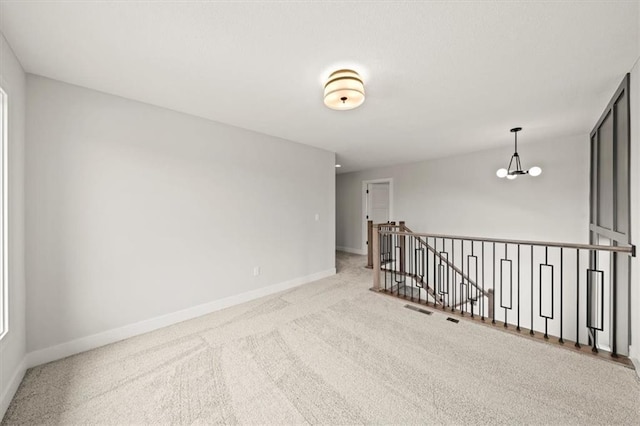 unfurnished room with baseboards, carpet, and visible vents