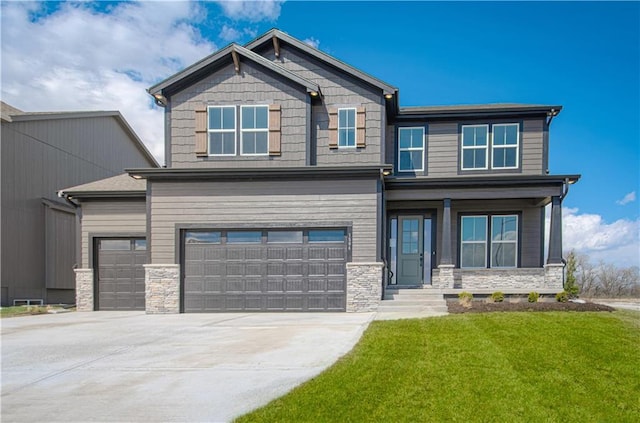 craftsman-style home featuring stone siding, an attached garage, driveway, and a front yard