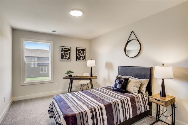 carpeted bedroom featuring baseboards and visible vents