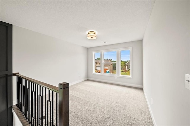 17157 S Laurelwood St, Olathe, KS 66062 - carpeted empty room featuring baseboards and a textured ceiling