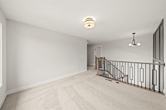 17157 S Laurelwood St, Olathe, KS 66062 - unfurnished room with baseboards, carpet, and a chandelier