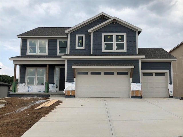 17157 S Laurelwood St, Olathe, KS 66062 - craftsman inspired home featuring covered porch, driveway, an attached garage, and a shingled roof