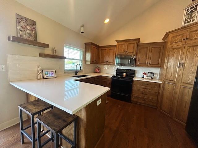 kitchen with brown cabinetry, open shelves, a sink, stainless steel microwave, and black range with electric cooktop
