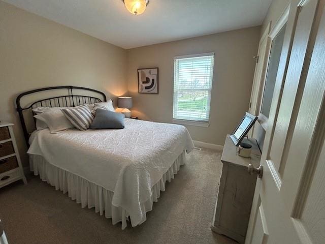 bedroom with baseboards and light carpet