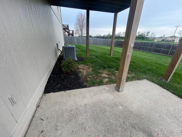 view of yard featuring central AC, a fenced backyard, and a patio area