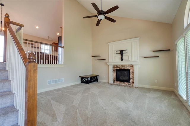 20534 W 199th Ter, Spring Hill, KS 66083 - unfurnished living room featuring high vaulted ceiling, ceiling fan, carpet floors, plenty of natural light, and a brick fireplace