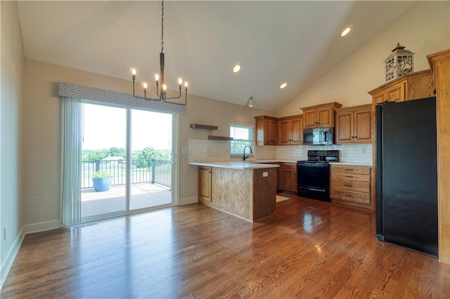 20534 W 199th Ter, Spring Hill, KS 66083 - kitchen featuring black appliances, a chandelier, a peninsula, brown cabinetry, and light countertops