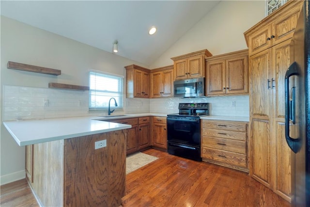 20534 W 199th Ter, Spring Hill, KS 66083 - kitchen with black electric range oven, stainless steel microwave, a peninsula, open shelves, and brown cabinets