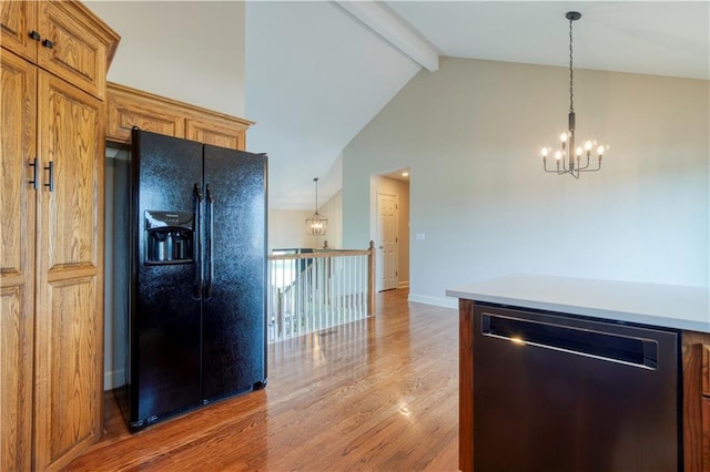 20534 W 199th Ter, Spring Hill, KS 66083 - kitchen featuring black refrigerator with ice dispenser, stainless steel dishwasher, a chandelier, beamed ceiling, and light wood finished floors