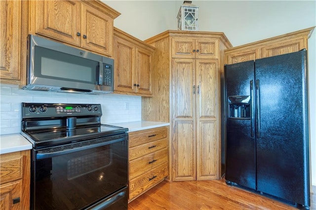 20534 W 199th Ter, Spring Hill, KS 66083 - kitchen with black appliances, light countertops, decorative backsplash, and light wood-type flooring
