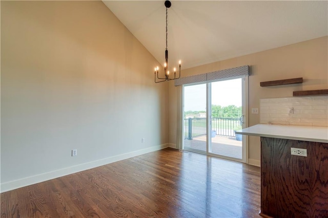 20534 W 199th Ter, Spring Hill, KS 66083 - unfurnished dining area featuring a chandelier, dark wood finished floors, and high vaulted ceiling