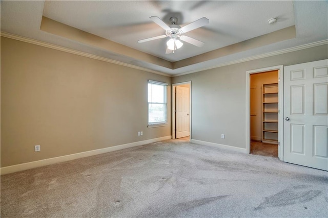 20534 W 199th Ter, Spring Hill, KS 66083 - unfurnished bedroom with a tray ceiling, carpet floors, a spacious closet, crown molding, and a ceiling fan