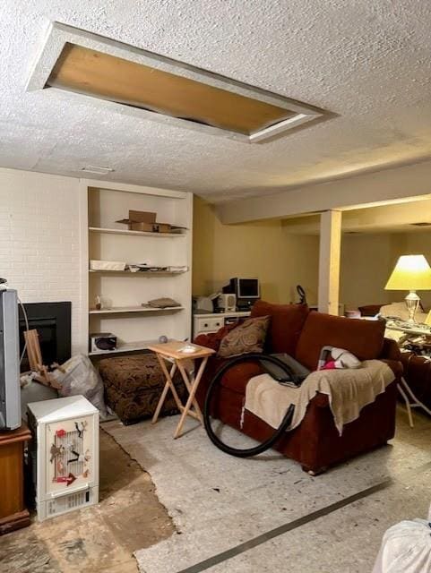 living area featuring a textured ceiling and a fireplace