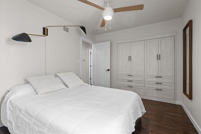 bedroom with visible vents, a ceiling fan, dark wood-style flooring, and baseboards