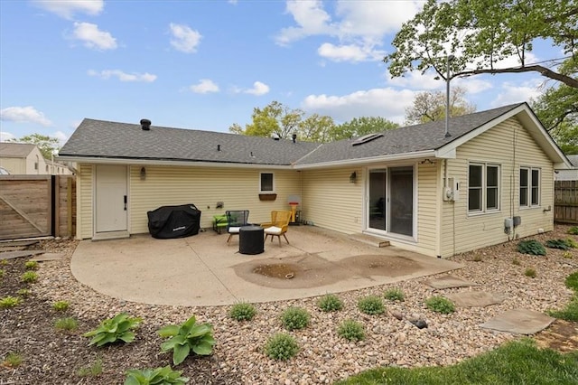 back of property with a gate, a patio area, and fence