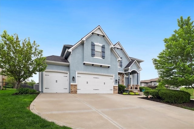 craftsman inspired home featuring fence, an attached garage, stucco siding, a front yard, and driveway