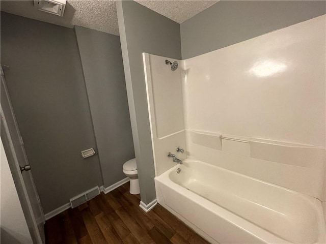 full bathroom with toilet, a textured ceiling, visible vents, and wood finished floors